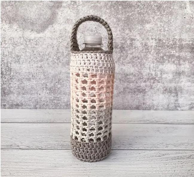 Crochet water bottle holder with strap.