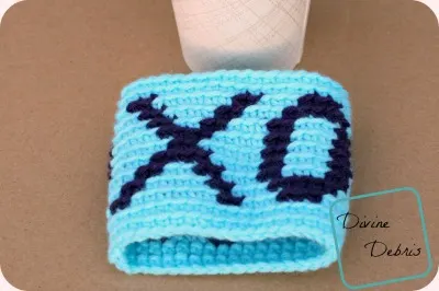 Discover the Crochet Hugs and Kisses Cup Sleeve – A Cozy Handmade Craft for Your Beverages